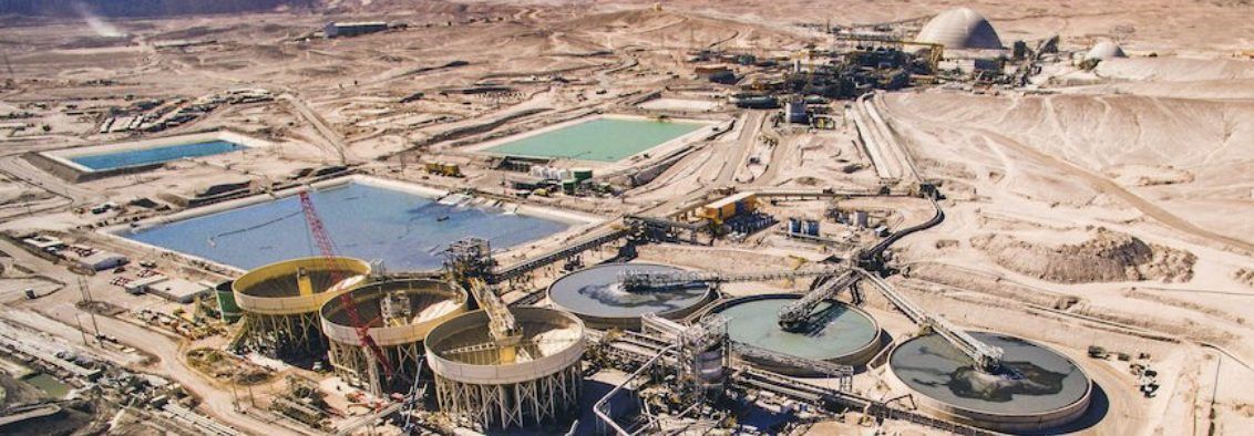 Aerial view of a concentrator plant with thickeners and process ponds in the desert