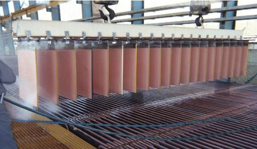 Copper cathodes being lifted in an electrowinning tank house